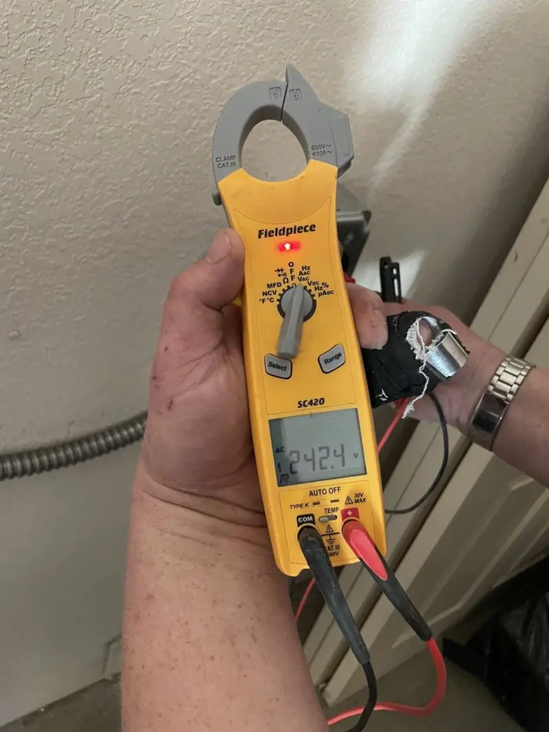 Voltage testing with clamp meter during Ceiling Fan Installation in Gunbarrel